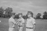 Colonel George D. Haskins pins Major William Willie Cline as Second Lieutenant Cleo Bynum Stands Waiting 1 by Opal R. Lovett