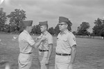 Colonel George D. Haskins pins Major William Willie Cline as Second Lieutenant Cleo Bynum Stands Waiting 2 by Opal R. Lovett