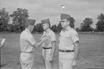 Colonel George D. Haskins pins Major William Willie Cline as Second Lieutenant Cleo Bynum Stands Waiting 3 by Opal R. Lovett