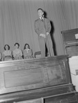 Male Stands at Microphone on Stage at JSTC by Opal R. Lovett