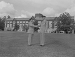 Lt. Col. John Brock Shakes Hands with First Lt. A.W. Bolt on Quad Behind Bibb Graves Hall 2 by Opal R. Lovett