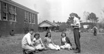 1950s Group Seated Outside Unknown Building by Opal R. Lovett