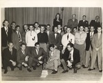 Football Coaches and Players Gather Admiring 1949 Paper Bowl Trophy by unknown