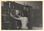 Assistant Librarian Nan Davis in Library by unknown