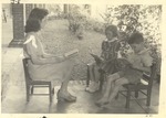 JSTC Elementary Laboratory School Faculty Member with Two Children Reading by unknown