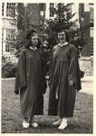 Two JSTC Female Students in Cap and Gown outside Bibb Graves Hall by unknown