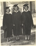 Three JSTC Graduating Seniors outside Bibb Graves Hall in Cap and Gown by unknown