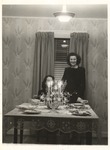 Two Females at Table with Lighted Candles by unknown