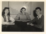 Three Students Seated around Table by unknown