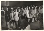 Training School Choir Members Singing inside Gymnasium by unknown