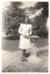Unidentified Female Stands Next to a Water Fountain by unknown