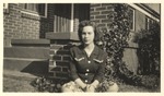 Unidentified Female Seated in Front of a House by unknown