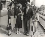 President Houston Cole Stands with Three Females at Train Station by unknown