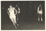 A Dancer and Two Twirlers Perform on a Field by unknown