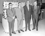 A.D. Edwards, Coach Don Salls, President Houston Cole, and James Haywood Standing in Front of Decorated Football Display by Opal R. Lovett