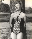 Female Individual Dressed in Bathing Suit Leaning Against Tree on Campus 3 by unknown