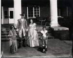 Man and woman dressed in colonial costume (possibly as young George and Martha Washington), with two children and a dog for George Washington Day at Jacksonville State Teachers College, circa 1932 by Russell Brothers Studio