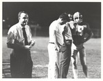 Coaches Charley Pell and Clarkie Mayfield along with James Haywood, Director of Food Services, on Sidelines during Football Game by Opal R. Lovett