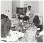 Professor or Guest Speaks Front of Classroom Filled with Students, circa 1980s by unknown