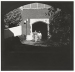 Students on Sidewalk Near Campus Building, circa 1980s by unknown