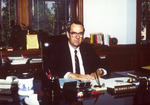President Harold McGee Seated at Desk in Office 2 by unknown