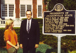 President Harold McGee beside JSU Presidents sign outside Bibb Graves Hall by unknown