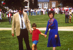 President Harold McGee, wife Gayle Stevens McGee, and son during campus event on quad by unknown
