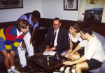 President Harold McGee seated with students in office by unknown