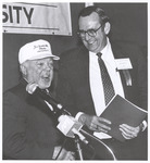 President Harold McGee, Host, stands with Individual at Podium, circa 1990s by William Edward Hill