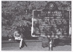 Student Sits in Courtyard near Forney Historical Society Marker, circa 2000 by unknown