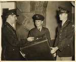 Cadet Lt. Col. Sam Jones and Cadet Capt. Rex Cosper Present Gift to Sgt. Ralph Carter by unknown