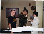 Military Nurse with Patients 2, circa 1988 by unknown