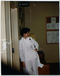 Female Individual Wearing Medical Uniform Standing in Doorway 2, circa 1980s by unknown