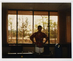 Individual Standing in Rowe Hall Lounge, circa 1989-1990 by unknown