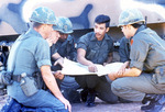 ROTC Cadets Huddle Making Plans, circa 1970s by unknown