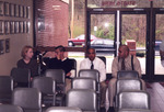 Four Individuals Seated in Chairs inside Rowe Hall Lobby, circa 1998 by unknown